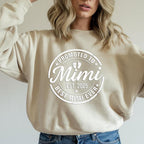 Grey t-shirt with black "Promoted to Grandma" print worn by woman outdoors.