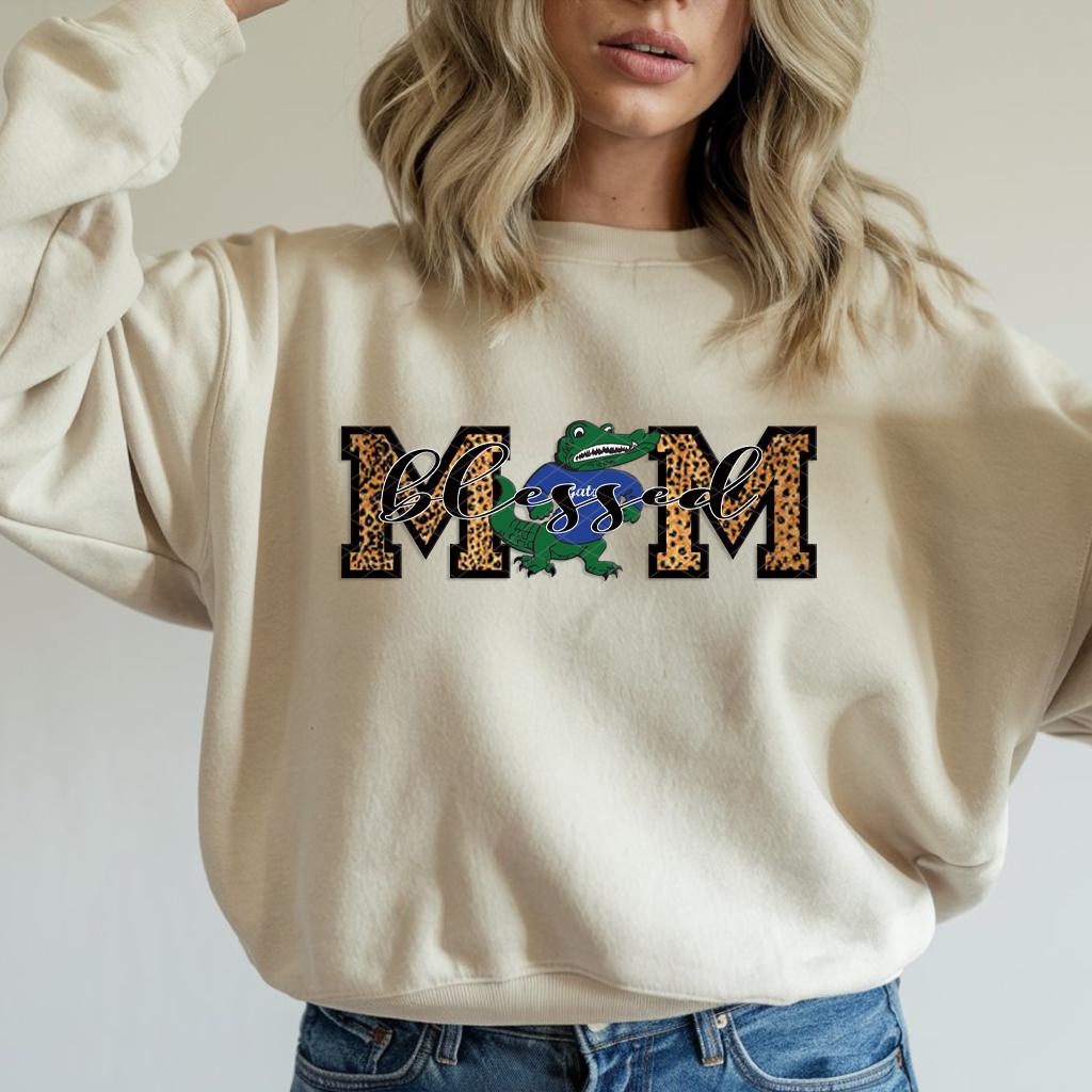 🐊 Celebrate your gator pride with our "Blessed Gator Mom" sweatshirt! Perfect for supporting your favorite team, showing school spirit, or rocking casual mom style with a pop of fun color.