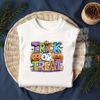 White tee mockup with colorful Trick or Treat ghost pumpkin DTF transfer”