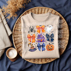 DTF transfer of coquette Halloween bows, haunted house, ghost, and pumpkin on beige shirt mockup