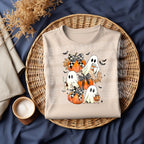Flat lay mockup of natural shirt with pumpkin ghost and bow DTF transfer applied