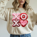 XOXO Valentine faux chenille style DTF heat transfer on beige sweatshirt with textured heart design