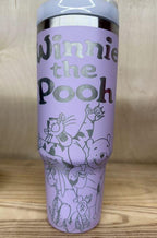 May include: A lilac stainless steel travel mug with a lilac handle and a clear lid. The mug has a silver design engraved into it.