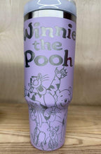 May include: A lilac stainless steel travel mug with a lilac handle and a clear lid. The mug has a silver design engraved into it.