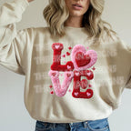 Beige sweatshirt with fuzzy chenille LOVE heart Valentine heat transfer design worn by model