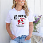 Be Brave Take WISCs with black and red writing on a white shirt, lifestyle mock up
