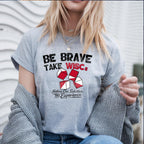 Be Brave Take WISCs black and red writing on a grey tshirt lifestyle mock up
