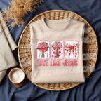 Love Like Jesus Christian Valentine shirt flat lay with floral bow cross design