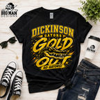 A black graphic t-shirt featuring a yellow and gold 'Dickinson Gators Gold Out Go Gators!' design with an alligator illustration, styled in a flat lay with jeans, sneakers, sunglasses, a coffee cup, and a plant on a light wood background.